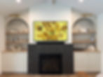 65" Samsung Frame TV w/ OneConnect box located in cabinet to the right of the fireplace