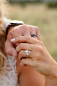 A Colorado wedding day photo of the details of the bride and groomhands. Highlight on the rings.