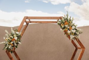 hillside gardens wedding venue ceremony site with wood and flowers