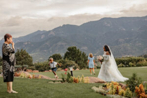 A candid photo of the bride, children, and guests, walking at Garden of the Gods Resort in Colorado Springs