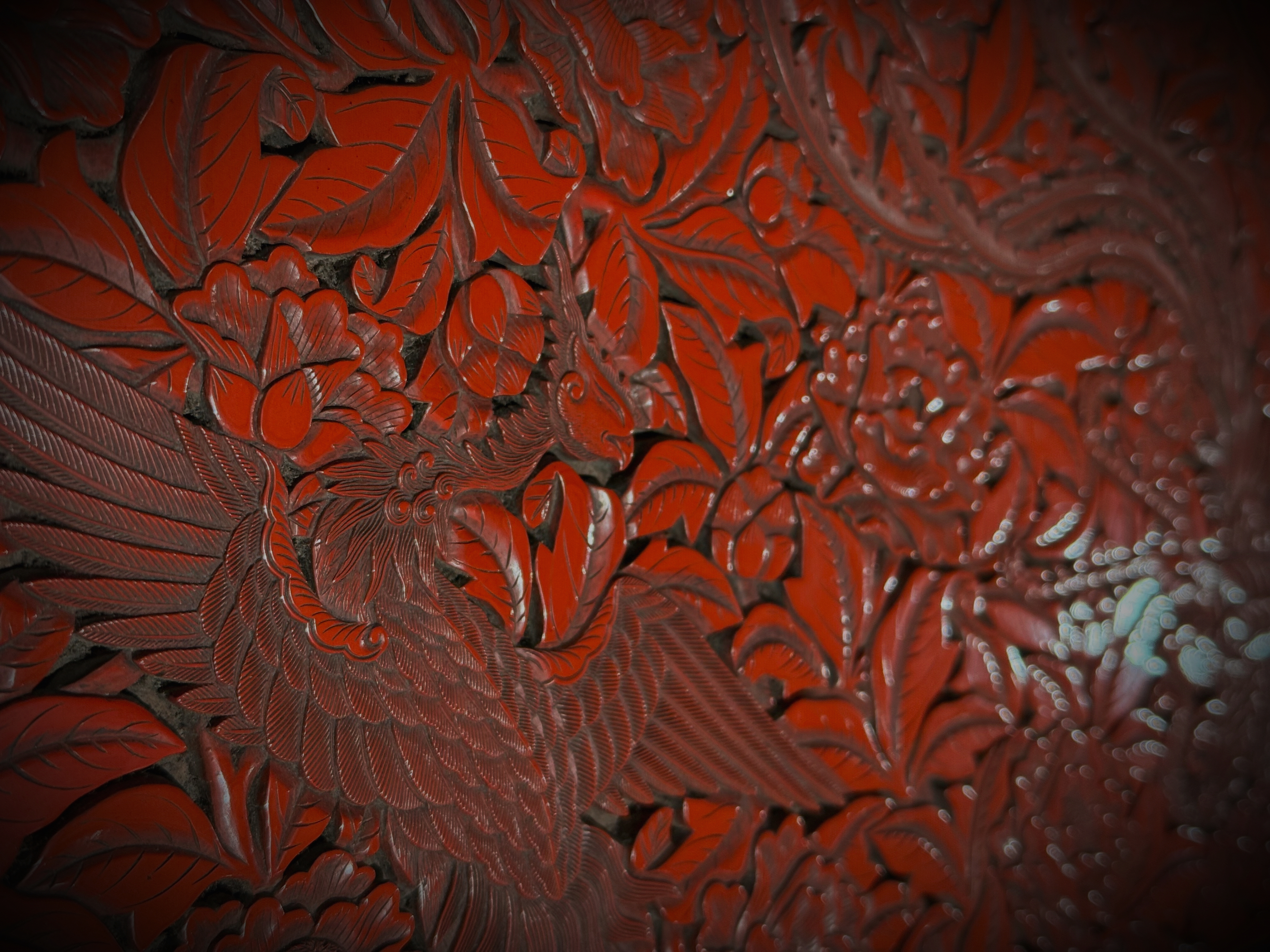 Close detail of a red carved artwork