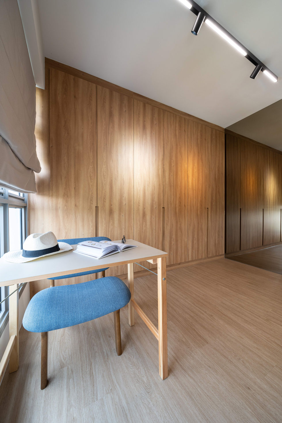 Modern bedroom with wood paneling and small desk