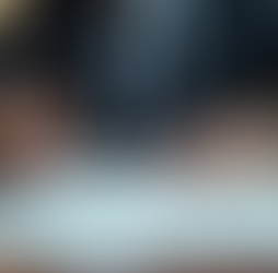 Woman holding a pen ready to sign contracts with a notary during a document notarization session