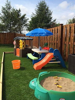 a-bright-and-fun-kids-play-space-with-a-colorful-dining-set-with-an-umbrella-a-mini-house-