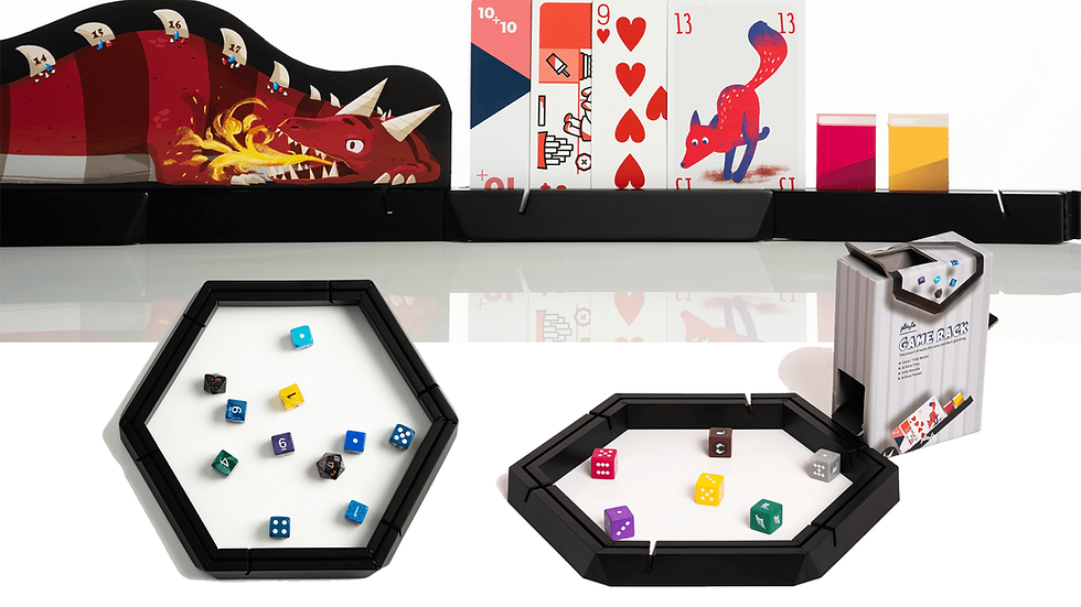 A row of cards on stand at the top, a hexagonal ring with dice, and the ring laid flat with the box shaped into a dice tower.