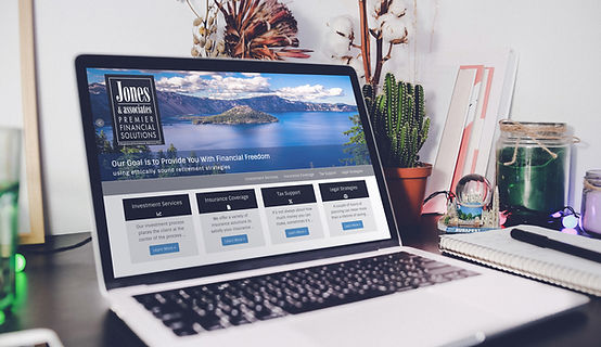 computer monitor showing a screen that has a laptop and homepage of a website