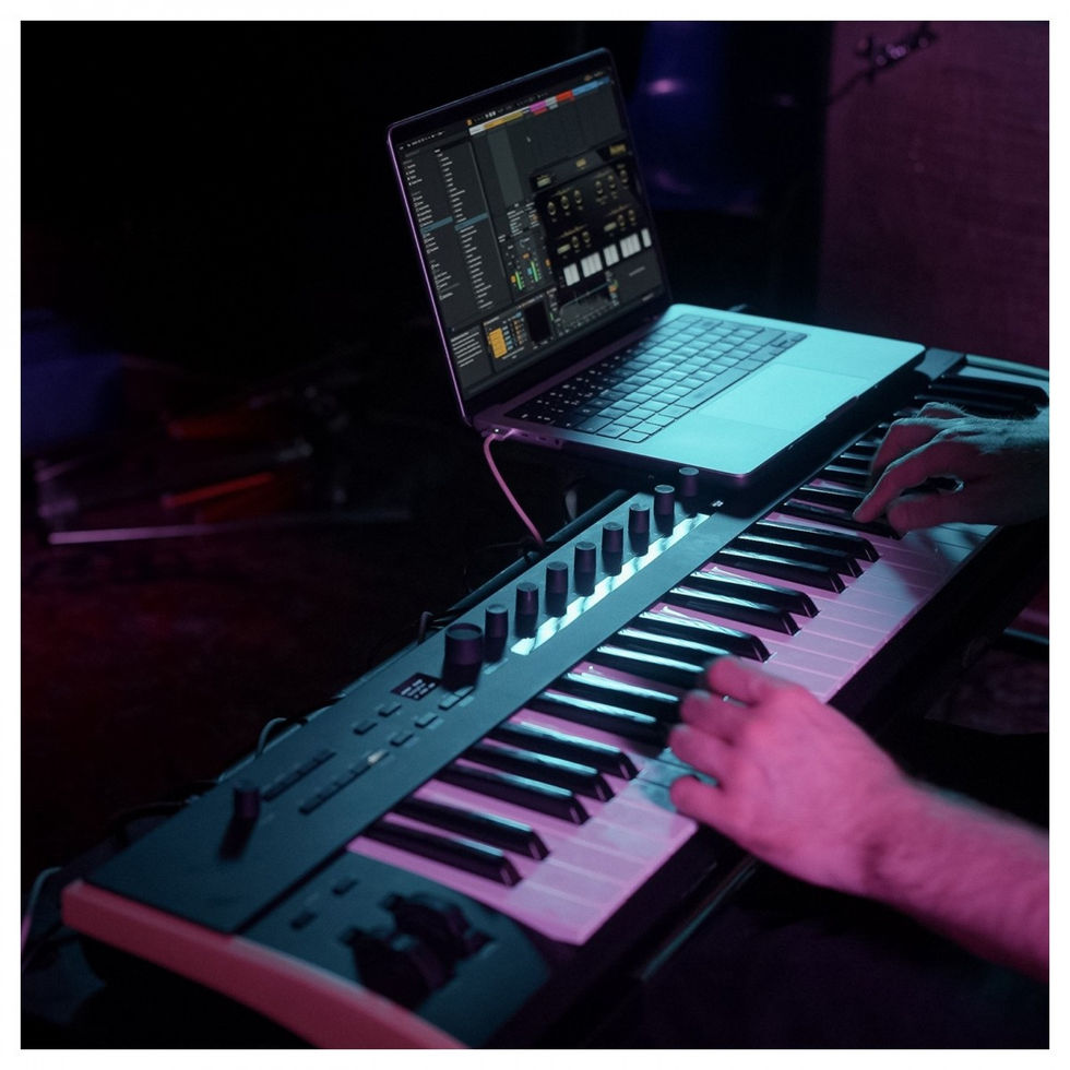 Image of Korg Keystage 61 Polytouch MIDI Keyboard being played with hand and laptop from the left side