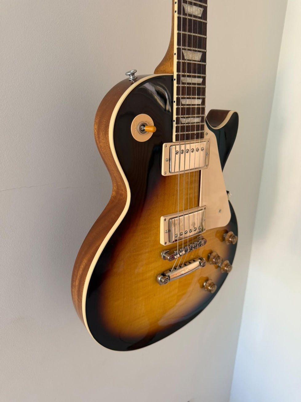 Front view of a Gibson Les Paul Standard 50s Figured Top - Tobacco Burst - 2024 - Secondhand body detail at slight angle