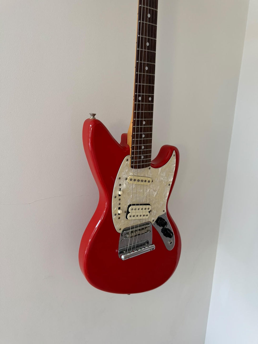 Front view at slight angle of Fender Kurt Cobain Jag-Stang - Fiesta Red