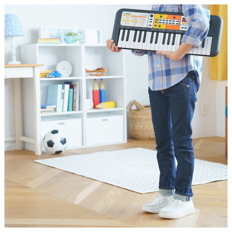 Image of Yamaha PSS-F30 Portable Keyboard being held by a child in a room