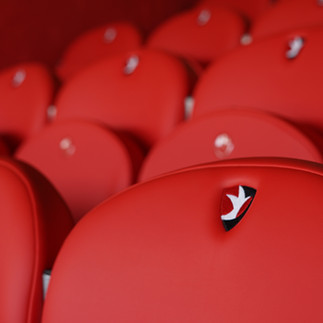 Embroidered Cheltenham Town FC club crest detail on bespoke upholstered stadium seating