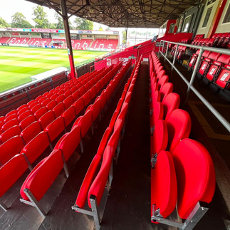 Football stadium seating installation showing Link Mirage seats with pitch view at Cheltenham Town FC