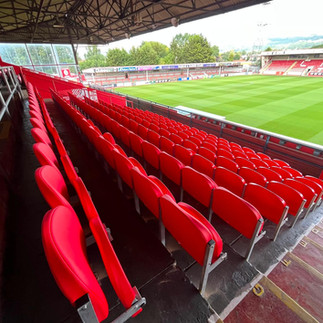 Rows of newly installed Mirage stadium seats overlooking the pitch at Cheltenham Town FC Whaddon Road