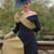 Thumbnail: Close-up of Veni Infantino 992554 Navy and Olive occasion dress showing its asymmetric neckline, pleated bow and three-quarte