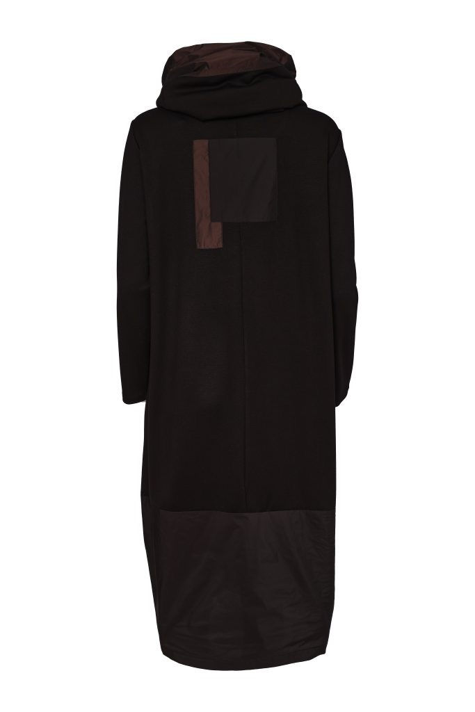 Thumbnail: Front view of the NAYA black jersey tulip dress styled with a statement geometric necklace and black leggings.