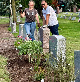 Native plantings at the cemetary. Two gardeners smile at the camera.