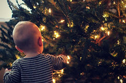 Baby Admiring a Christmas Tree