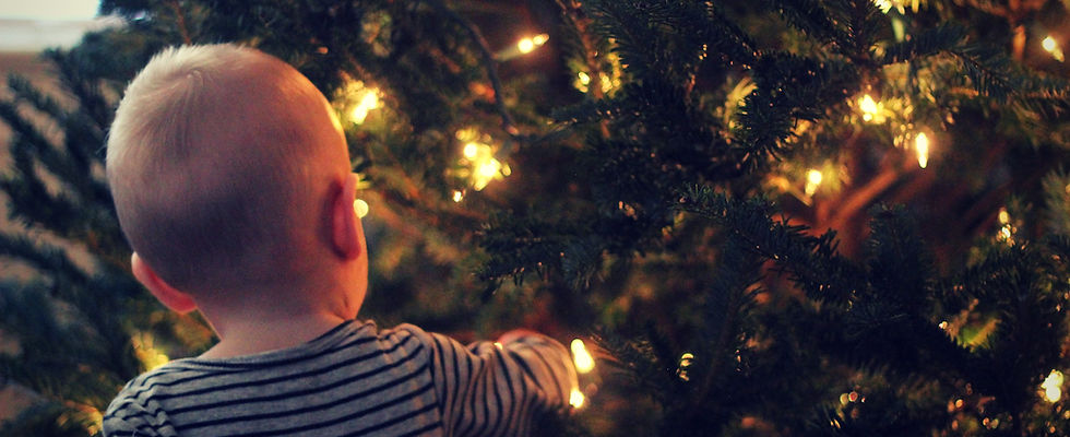Baby Admiring a Christmas Tree