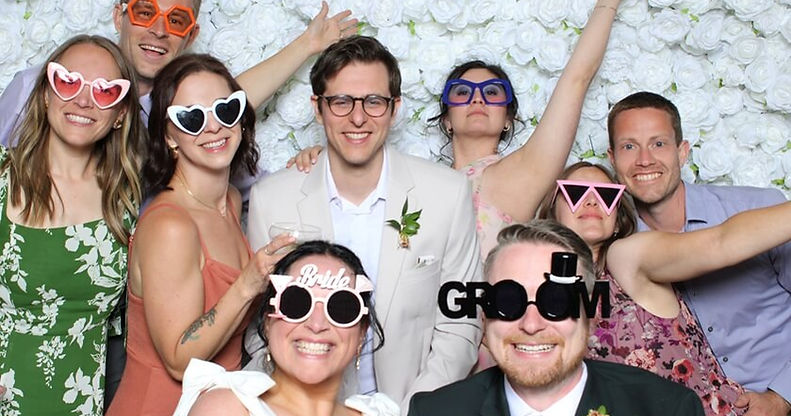 wedding couple and friends posing in a photo booth