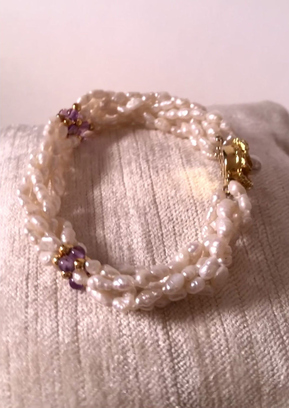 Thumbnail: freshwater pearl twisted strand bracelet with amethyst and gold beads accents with an ornate push close clasp