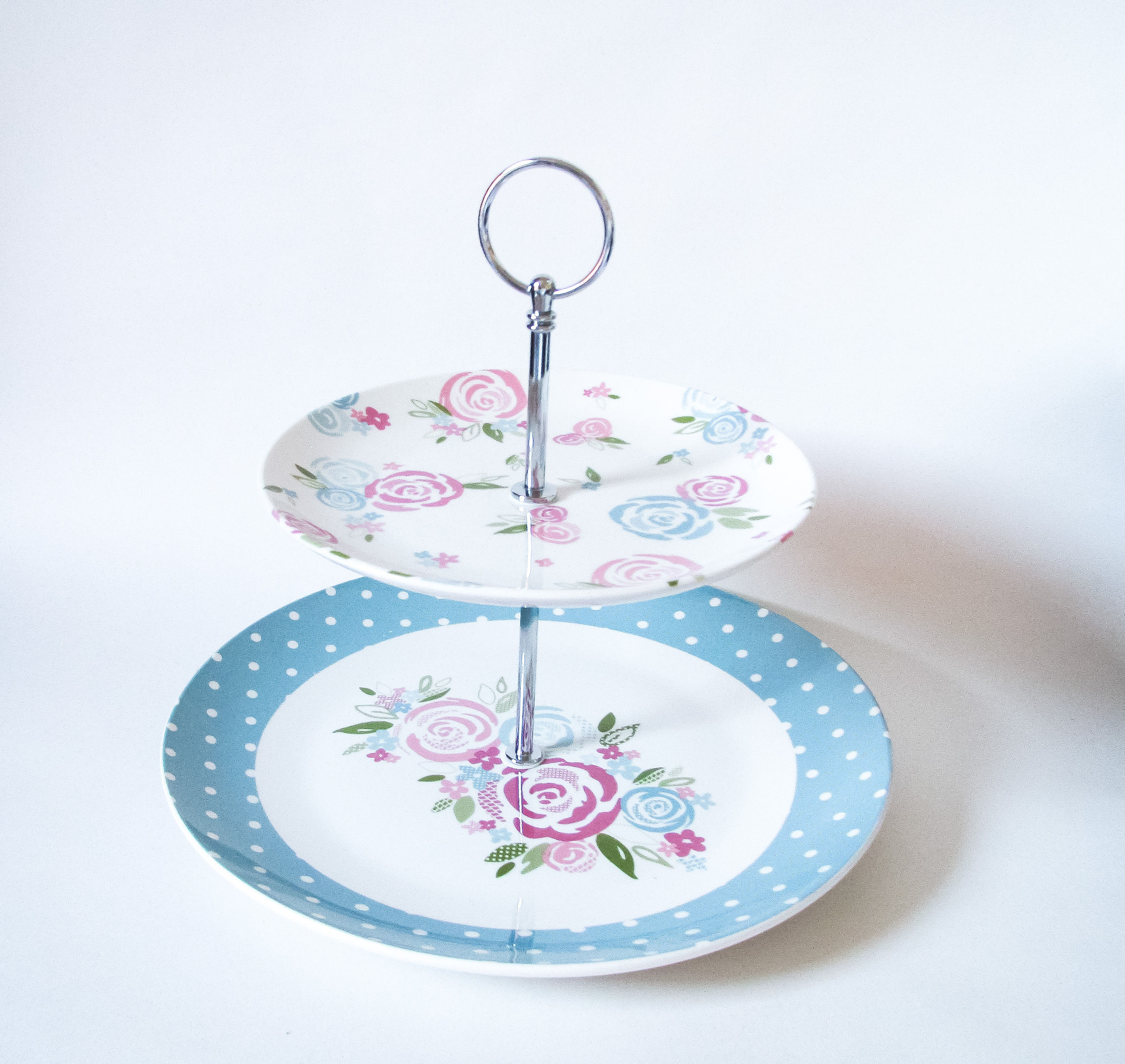two tier cake stand decorated with stylised roses and teal blue and white polka dots