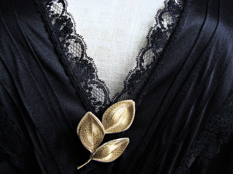 Wire leaf sprig brooch on front of slip G&BA