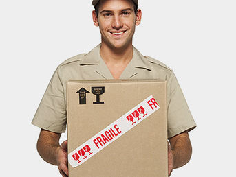 A delivery person holds a box marked "fragile."