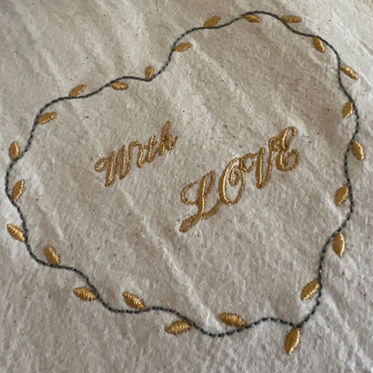 1. Heart shaped towel with gold 'With Love' embroidery.
2. Gold 'With Love' embroidery on heart shaped towel.
3. Heart shaped towel featuring gold 'With Love' embroidery.
4. Towel with heart shape and gold 'With Love' embroidery.
5. Gold embroidery on heart shaped towel with 'With Love'.