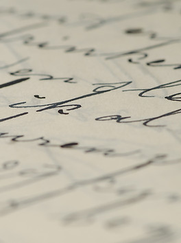 Black ink calligraphy on parchment with the center in focus 