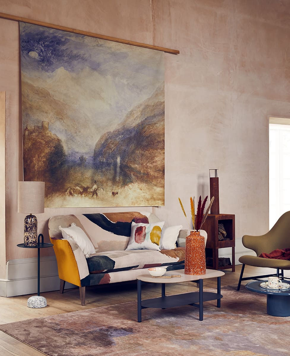 colourful-couch-under-tapestry-in-living-room