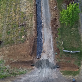 Widening a rural residential driveway with road fabric and crushed gravel