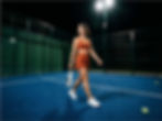 Woman walking across a padel court