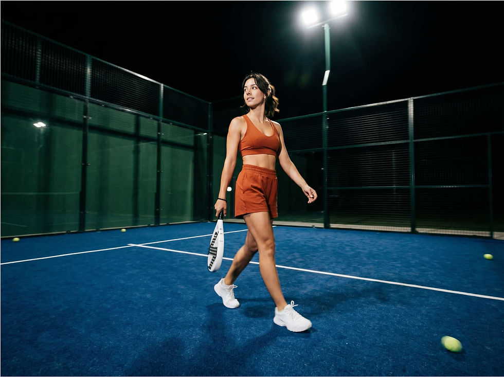 Woman walking across a padel court