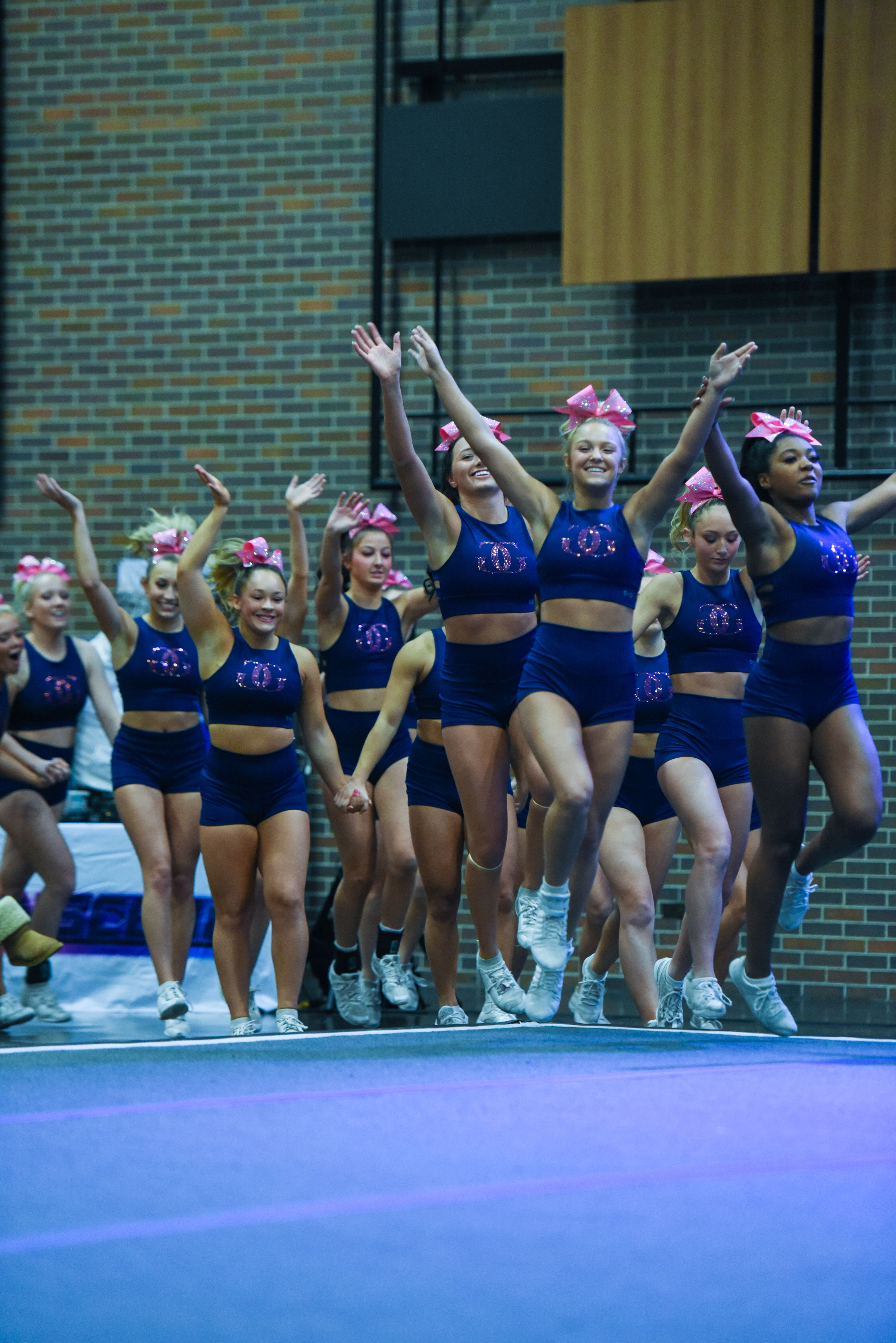 Cheerleaders celebrating as a team on the floor