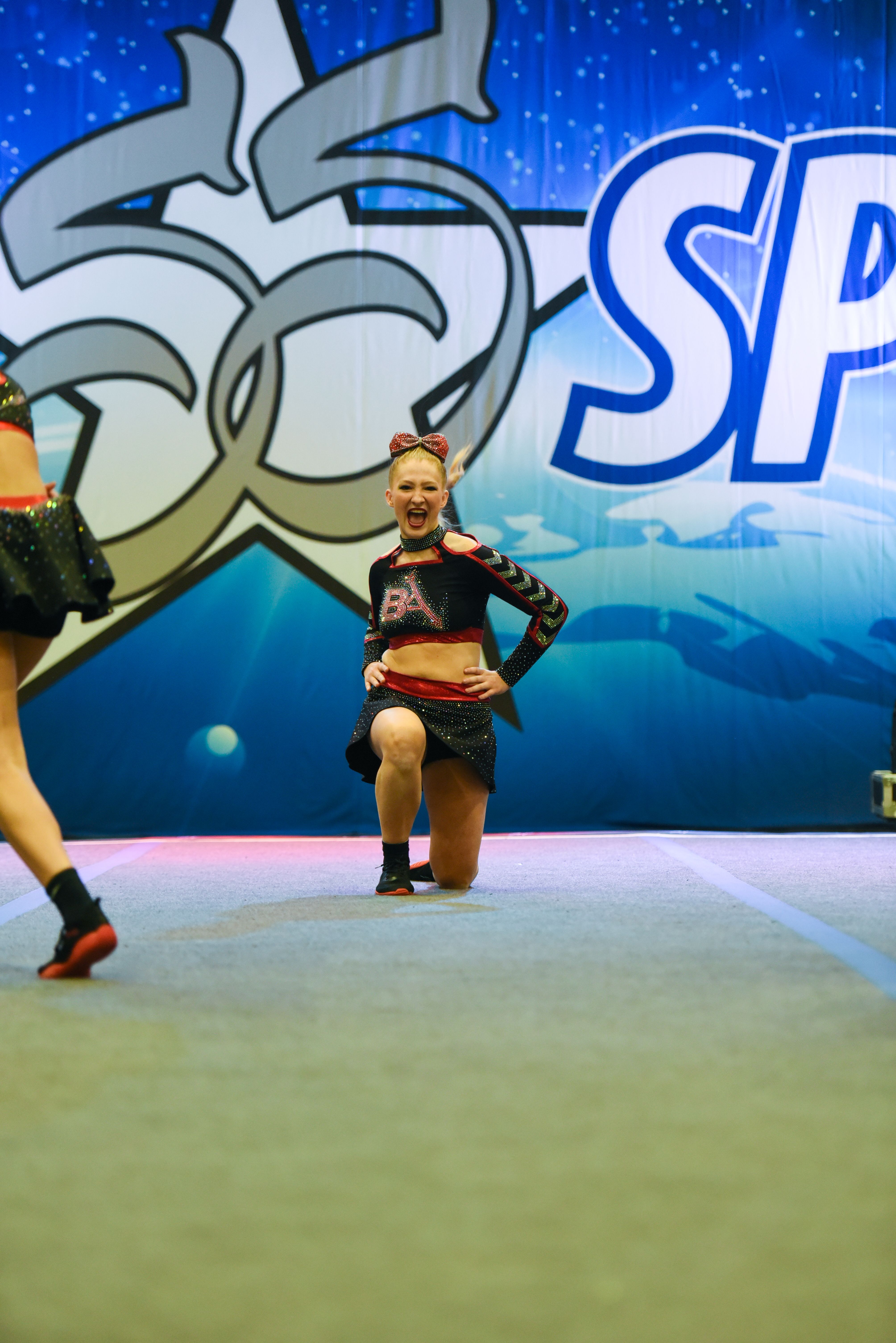 Cheerleaders performing on a Star Spirit competition floor