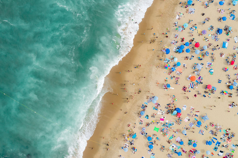 several people sun bathing on the beach