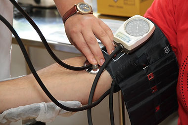 A woman takes another woman’s blood pressure