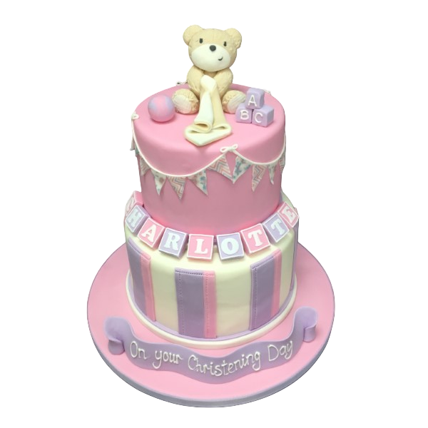 Bespoke celebration cake in Solihull, West Midlands featuring a teddy comforter, striped layers, and bunting decorations.