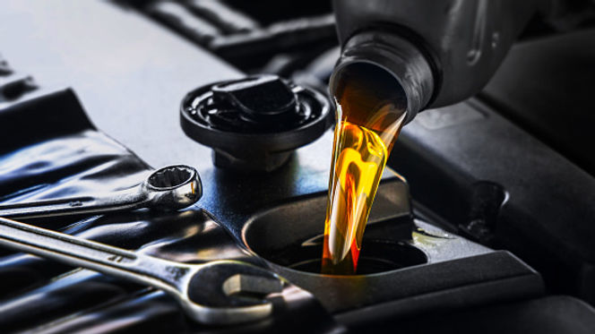 New oil being poured into engine during Royal Auto's regular maintenance