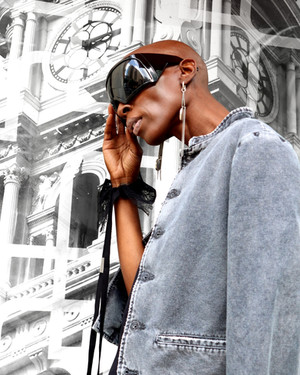 Model wearing Rick Owens sunglasses, Ann Demeulemeester jewelry, cuffs, & jacket, close up of upper body