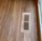 Wooden vent cover in hardwood floor