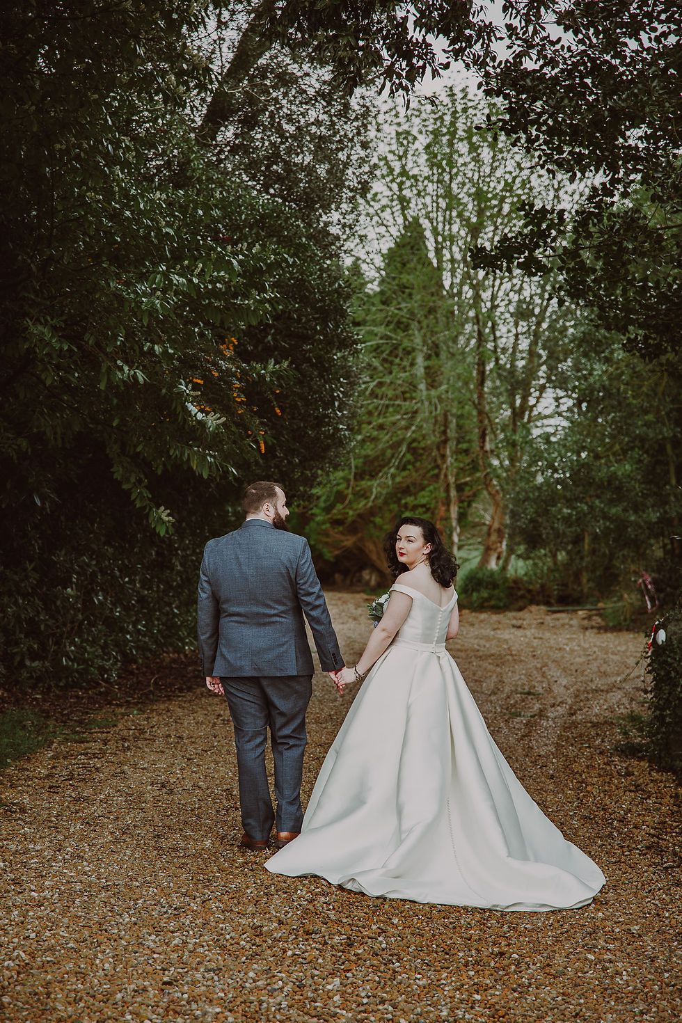 Romantic couple portrait in the gardens of Bron Eifion Hotel, captured by Manchester wedding photographer Kathryn Powers Photography
