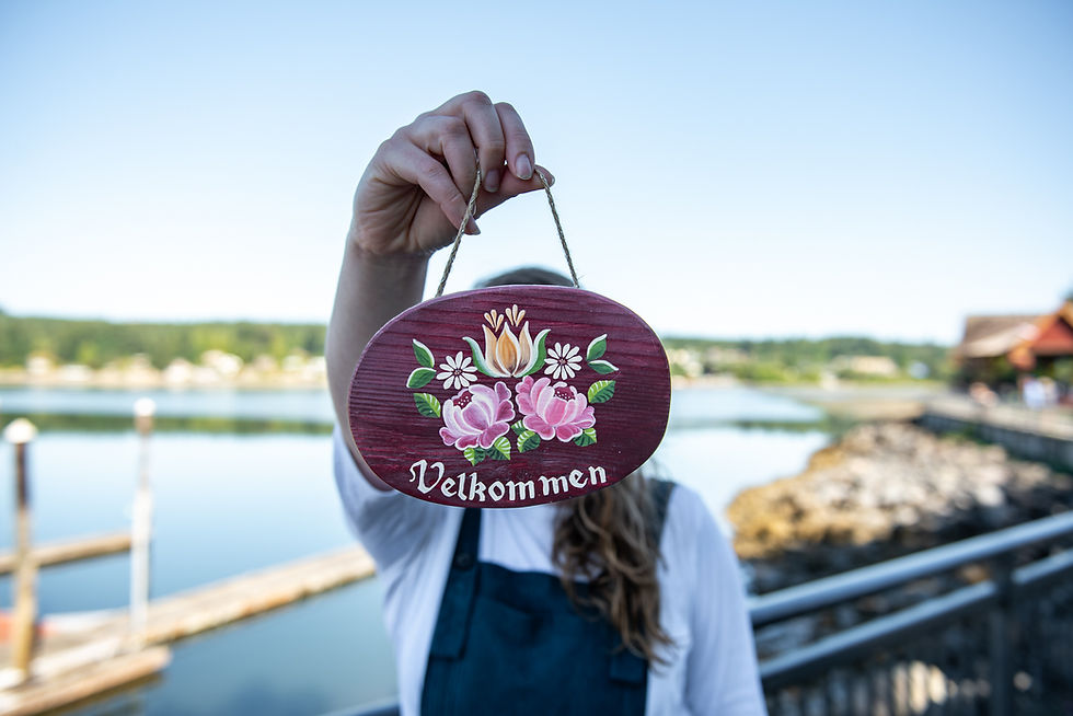 Welcome sign Poulsbo Washington held by brand designer and brand photographer Leah Thompson
