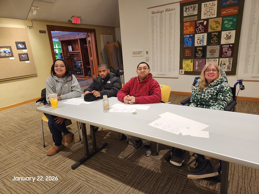 Four people sit at a table indoors