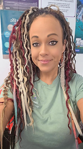 Woman with colorful dreadlocks in a green shirt