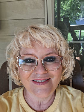 Smiling blonde woman with glasses for Who We Are page
