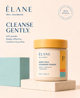 ÉLANE Goat’s Milk Cleansing Powder in a cream jar with a gold lid, displayed on a stone pedestal with aqua accents and campaign typography.