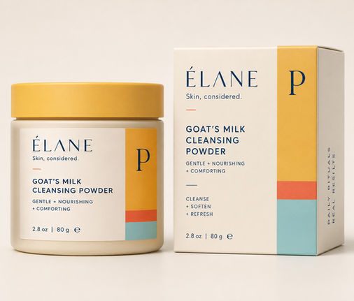 ÉLANE Goat’s Milk Cleansing Powder in a cream jar with a marigold lid displayed beside its coordinating rectangular product box.
