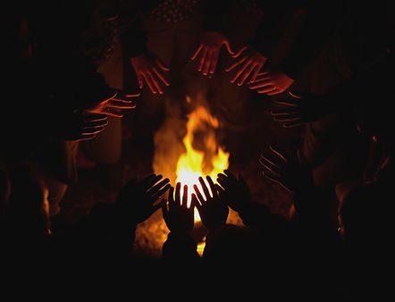 A circle of people silhouetted around a