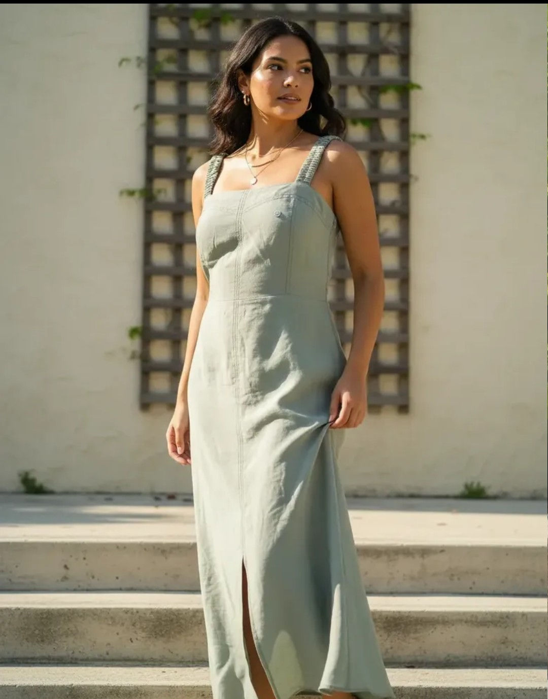Model wearing a sage green Marrant Tailored Dress outdoors.